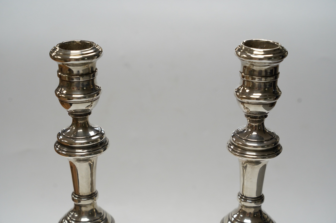 A pair of Elizabeth II silver candlesticks, with turned columns, London, 1958 (maker's marks rubbed, height 20.8cm, weighted. Condition - fair